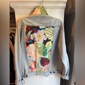 Custom oversized denim jacket with floral patched back and collar. Size large.